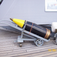 One of the Mark 7 shells on a trolley, along with a propellant bag. Up to six bags would launch the shell a maximum of 42,000 yards